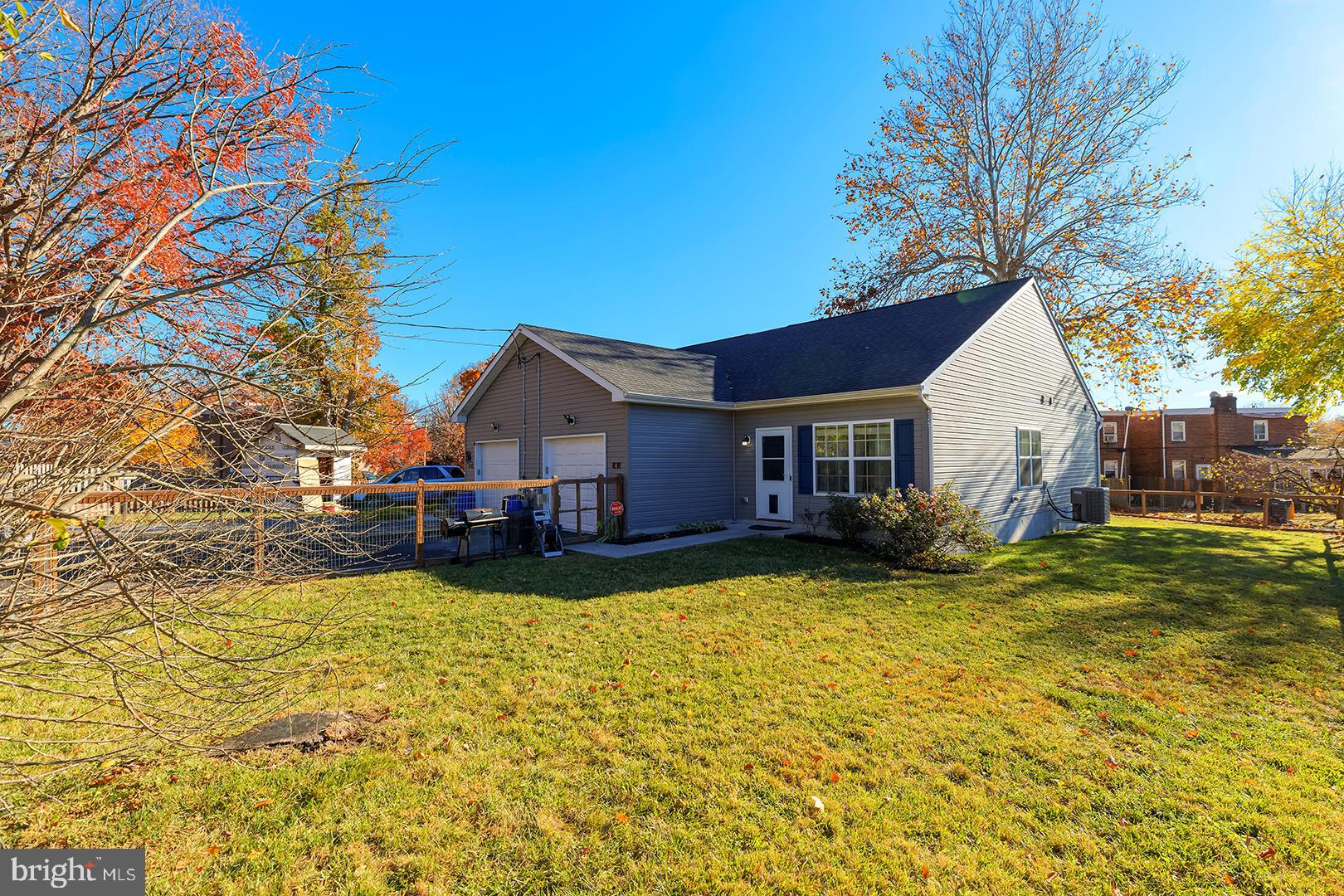 a view of a house with a big yard and large tree