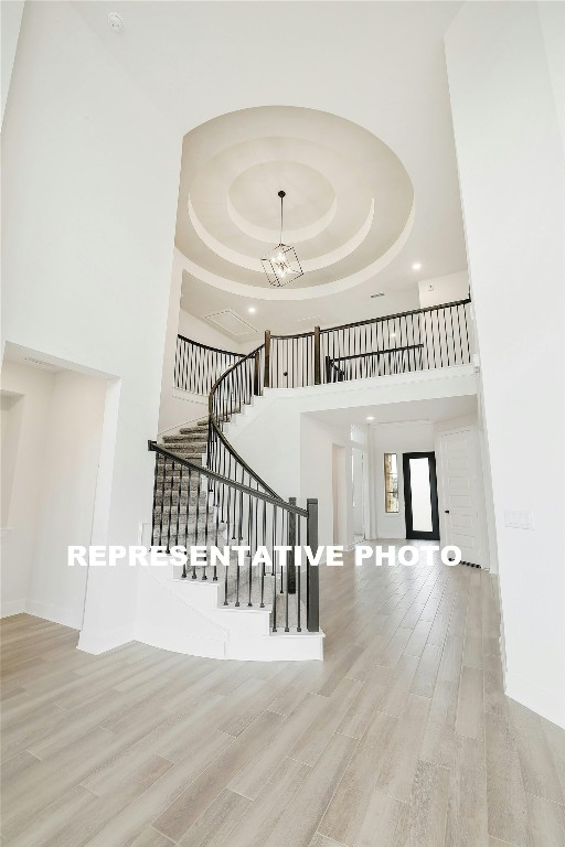 a view of a hallway with wooden floor and windows