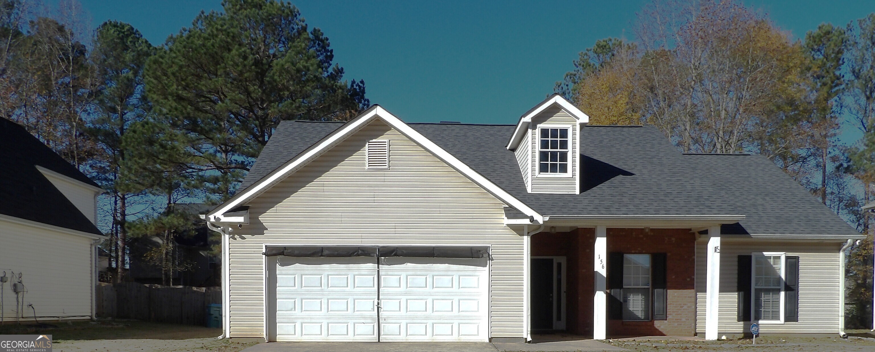 a view of a brick house with large windows