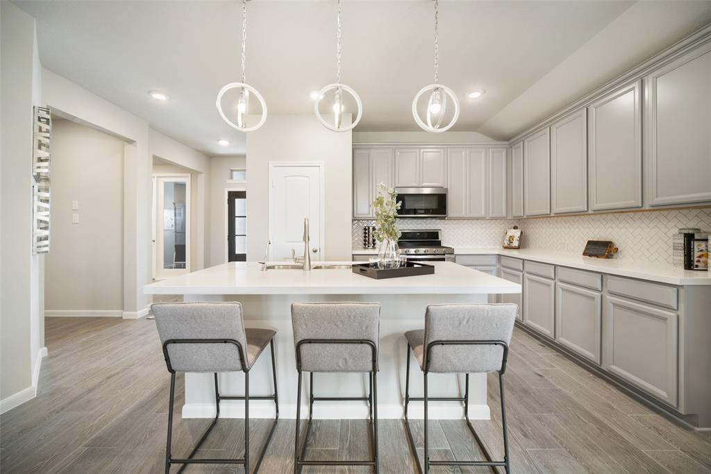 a kitchen with cabinets a sink and appliances