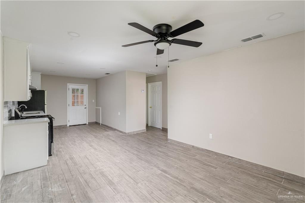 a view of a livingroom with a hardwood floor and a ceiling fan