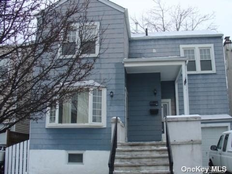 a front view of a house with stairs