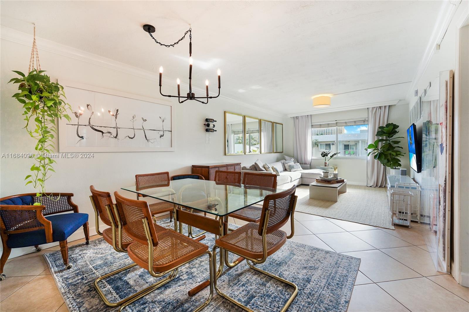 a living room with furniture kitchen view and a table