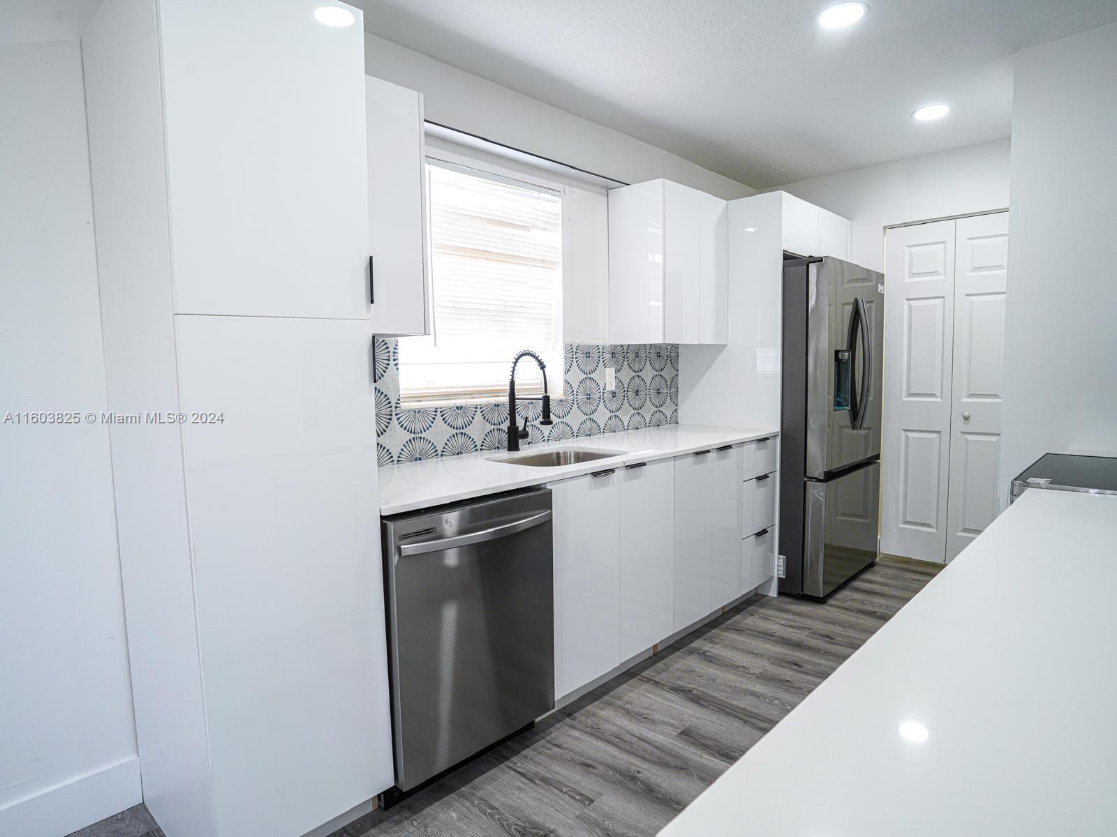 a kitchen with a sink stove and refrigerator