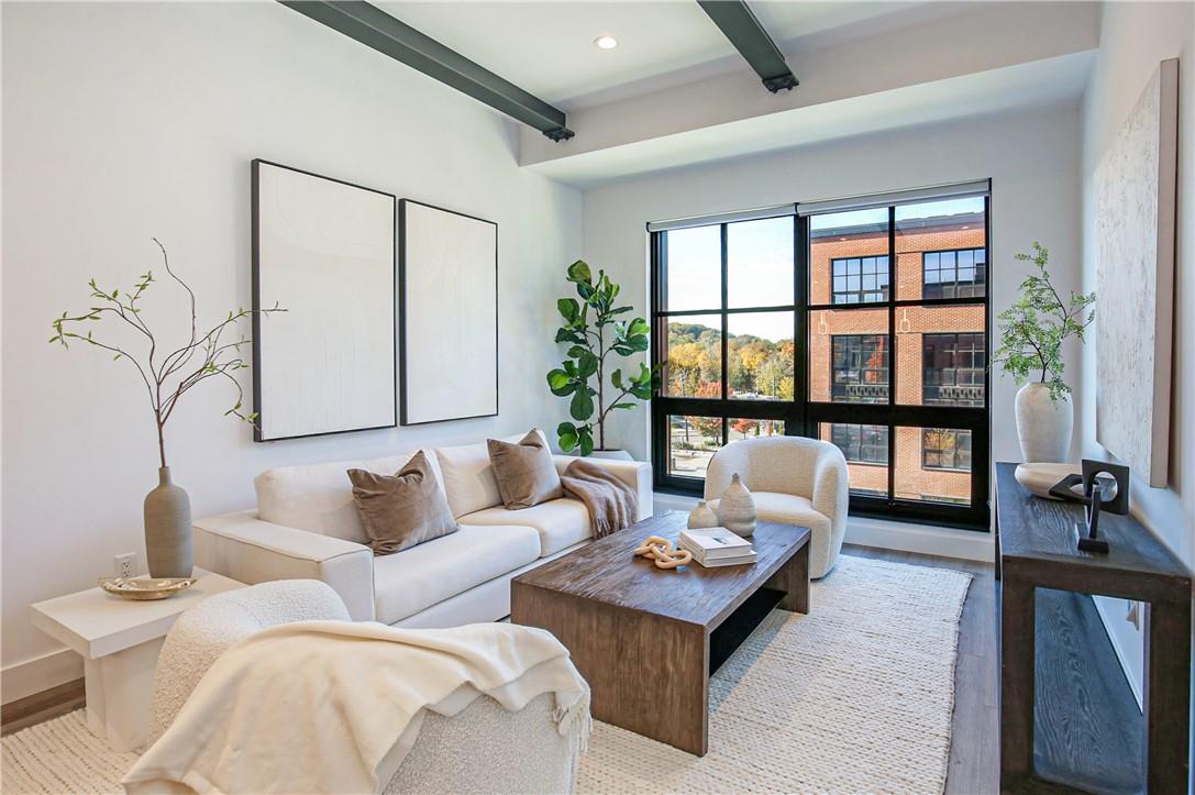 a living room with furniture and a floor to ceiling window