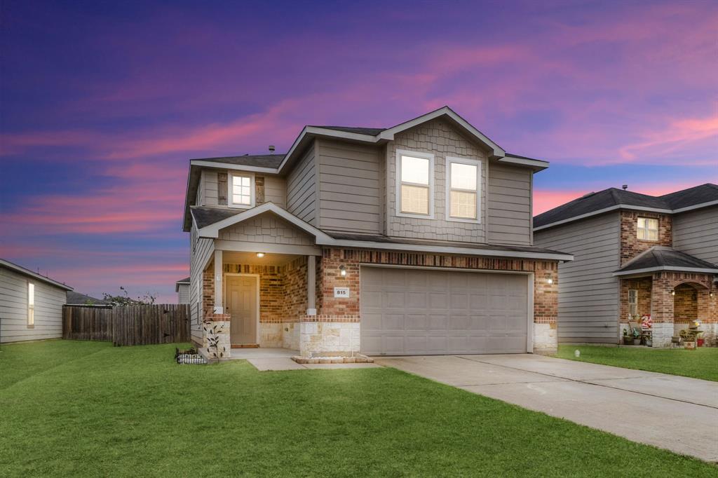 a front view of a house with a yard and garage