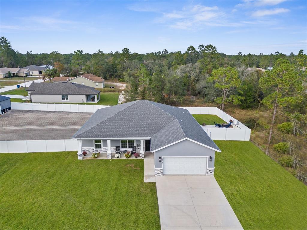 a aerial view of a house with a big yard