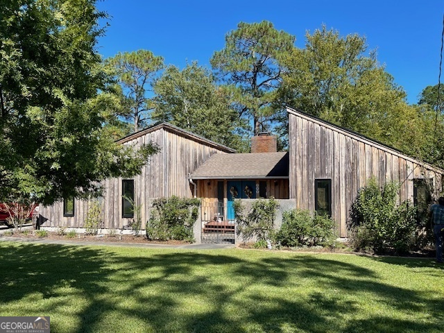 a front view of a house with a garden