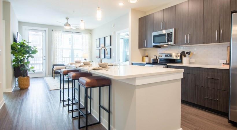 a kitchen with sink a microwave and cabinets