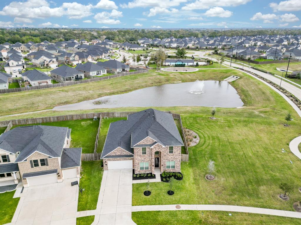 an aerial view of residential houses with outdoor space and river