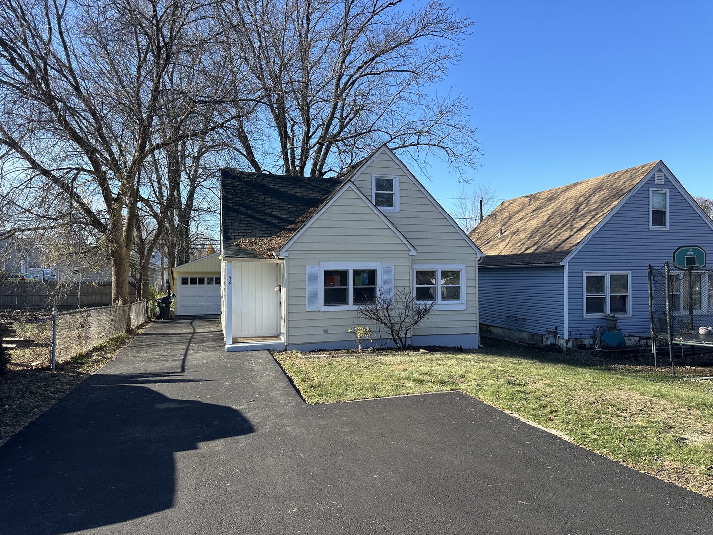 a front view of a house with yard and trees