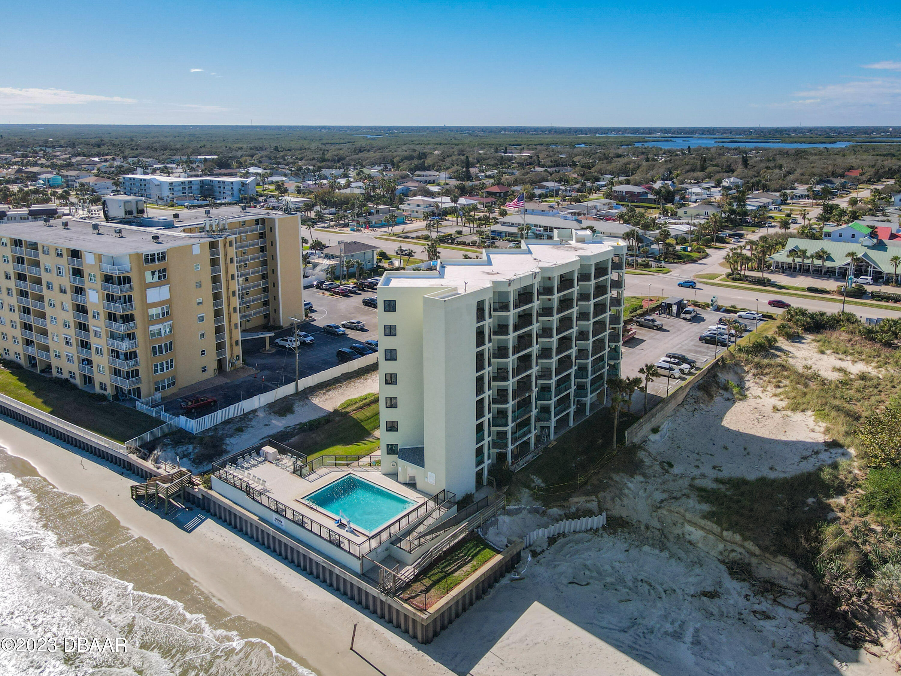 an aerial view of a residential building with an ocean view