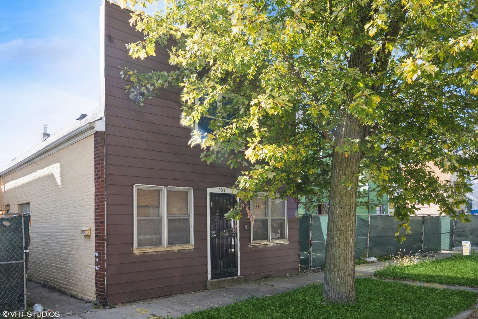 front view of a house with a tree