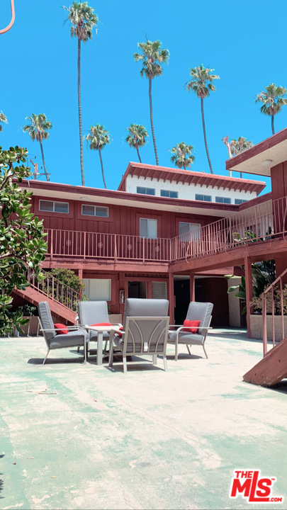 a roof deck with table and chairs