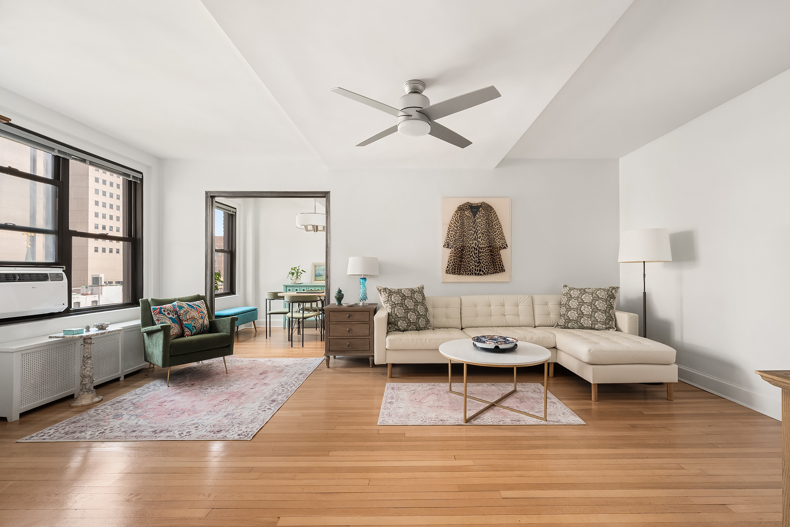 a living room with furniture and wooden floor