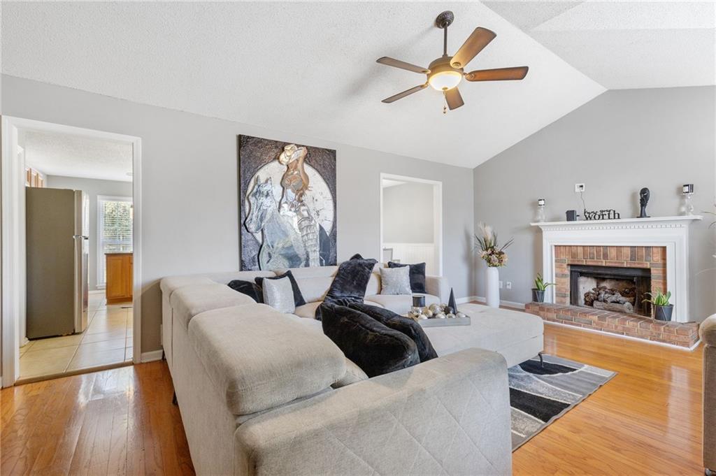 a living room with furniture chandelier and a fireplace