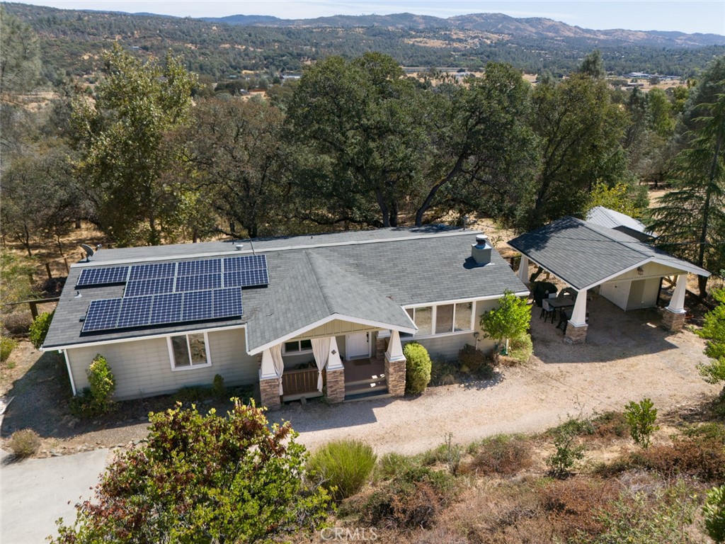 an aerial view of a house with a yard