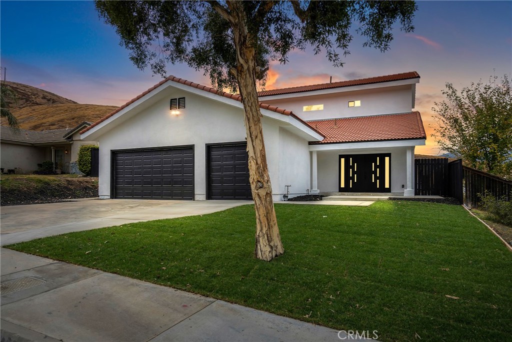 a front view of a house with a yard and garage