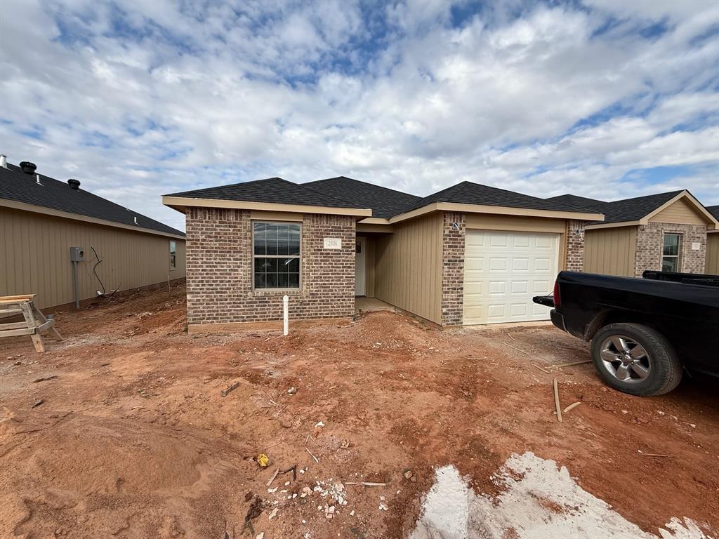 a front view of a house with parking space