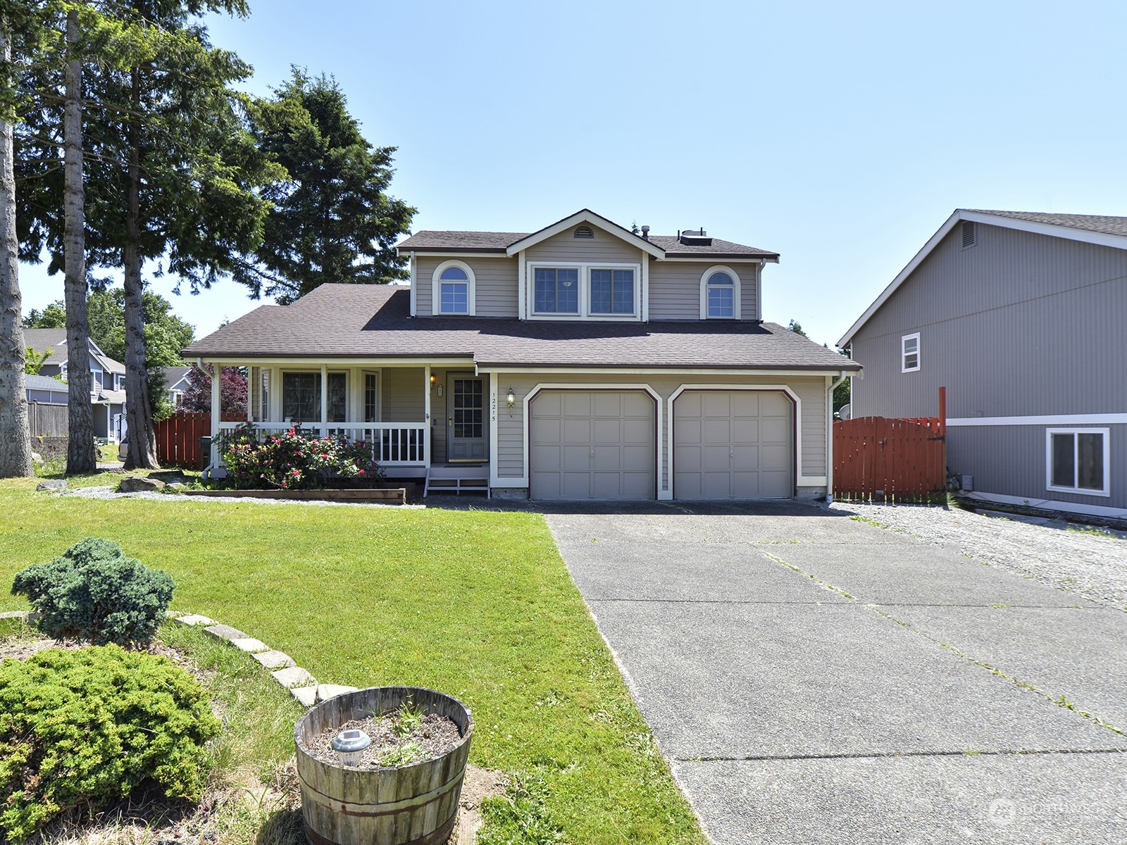 a front view of a house with a yard and garage