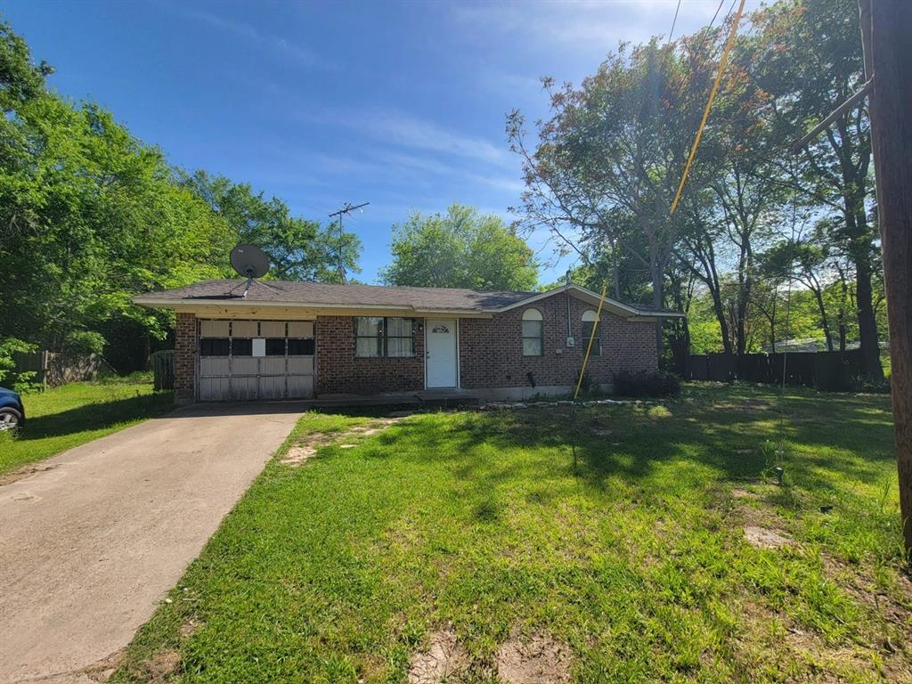 a view of a house with a yard and tree s