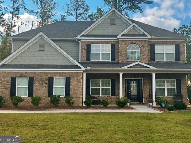 a front view of a house with a yard