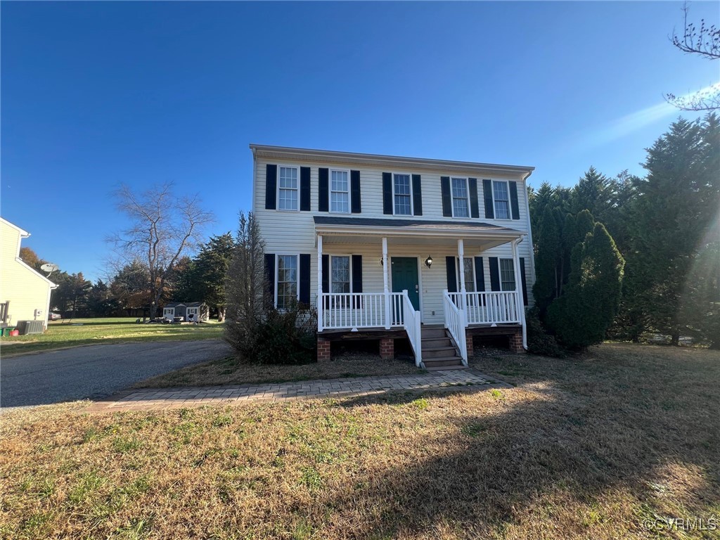 Colonial-style house featuring a front lawn and a