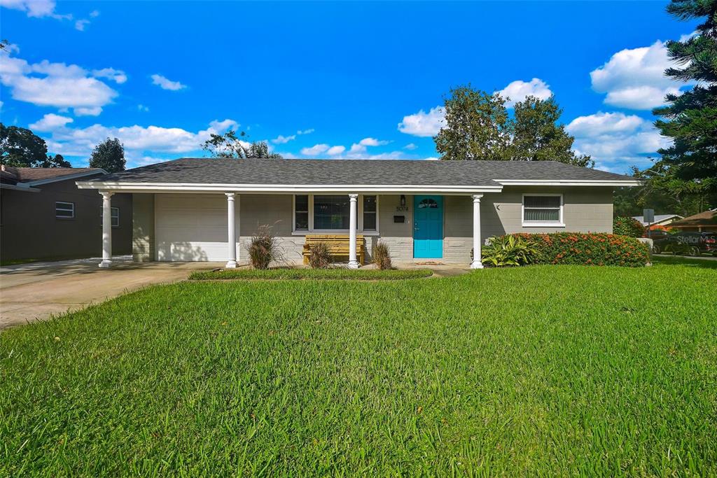 a front view of house with yard and outdoor seating