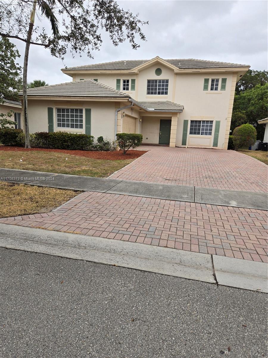 a front view of residential houses with yard