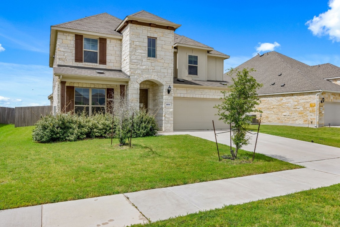 a front view of a house with a yard