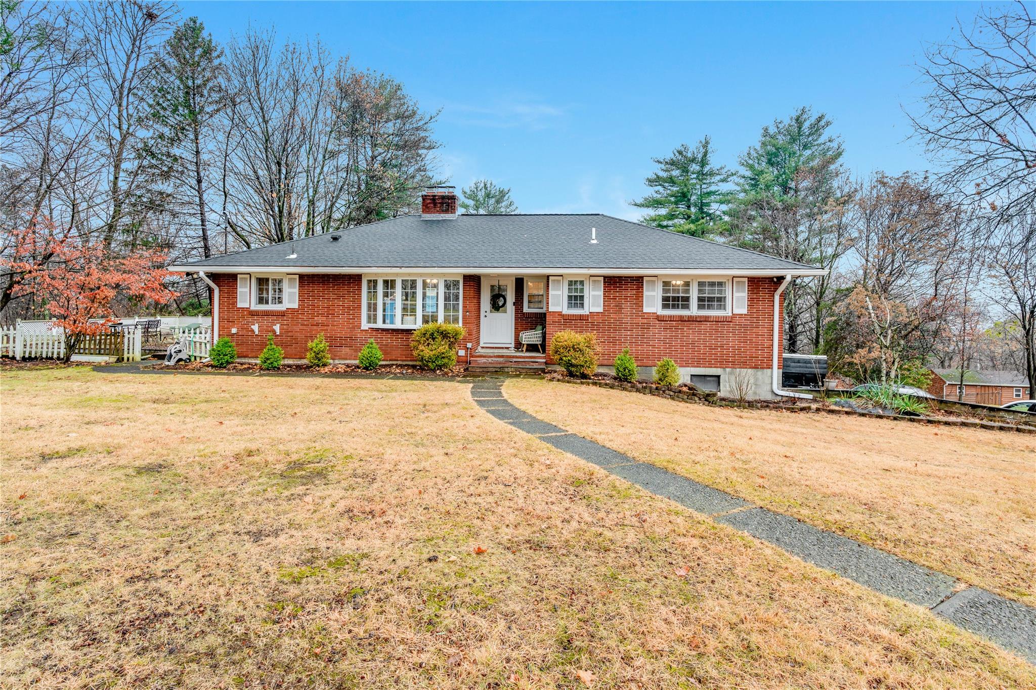 Ranch-style house featuring a front lawn