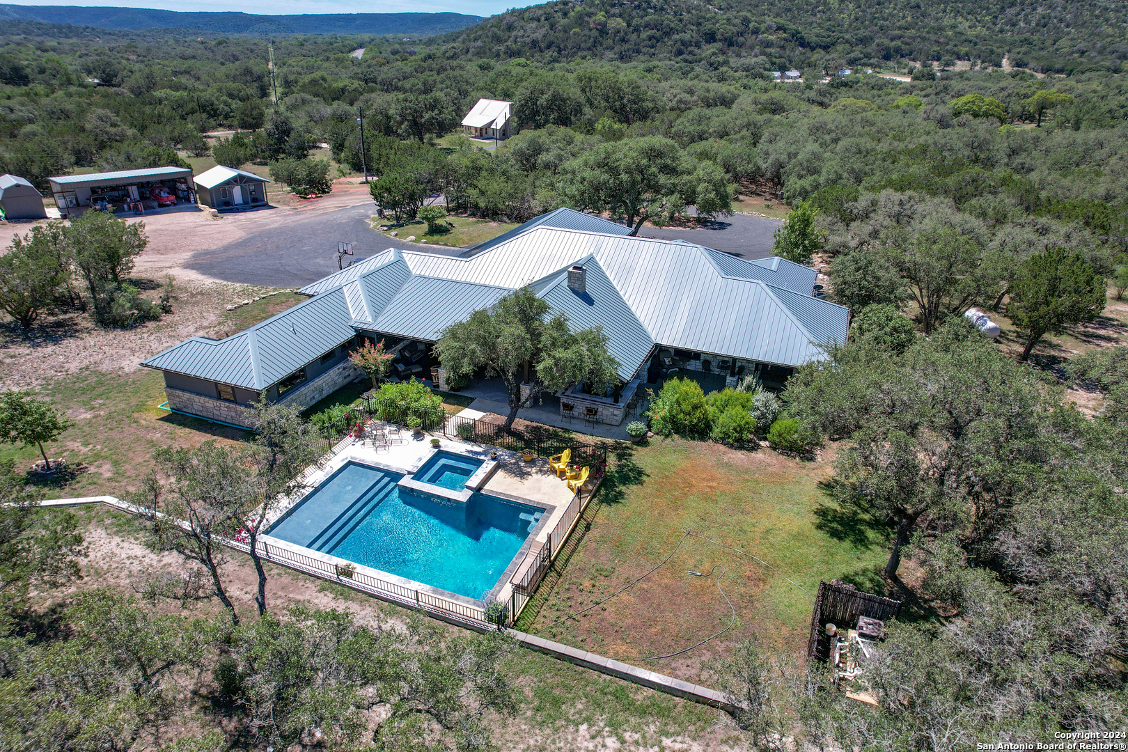 an aerial view of a house with swimming pool and outdoor space