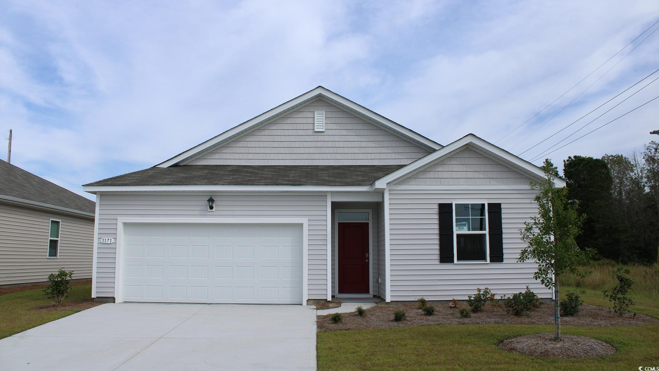 View of front of property with a garage and a fron