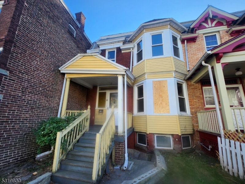 a view of a brick house with many windows