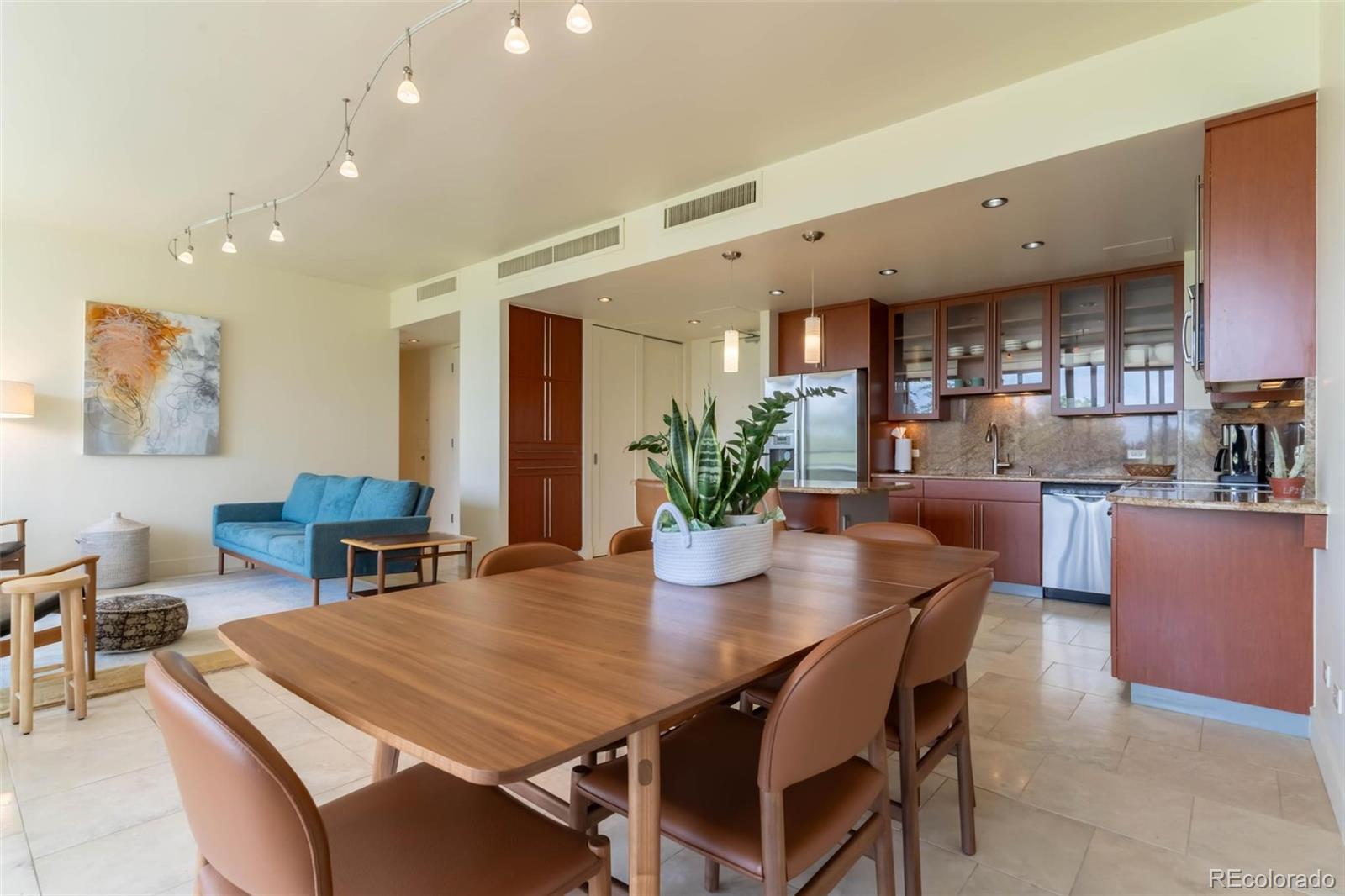 a dining room with kitchen island a table and chairs in it