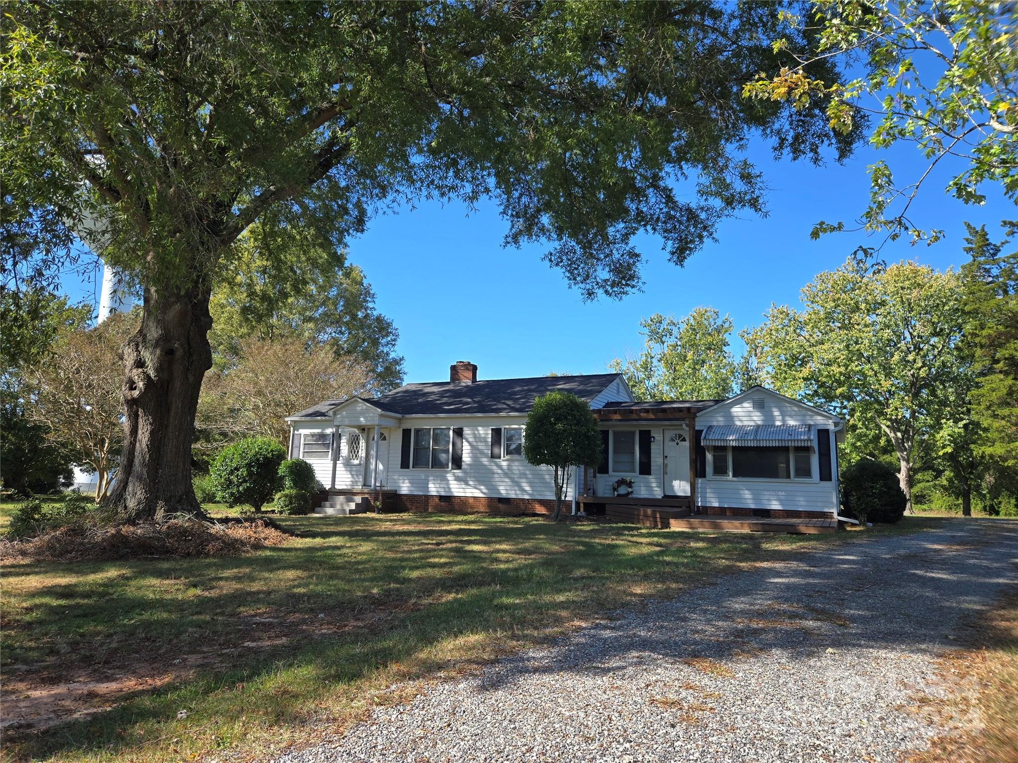 a front view of a house with a big yard