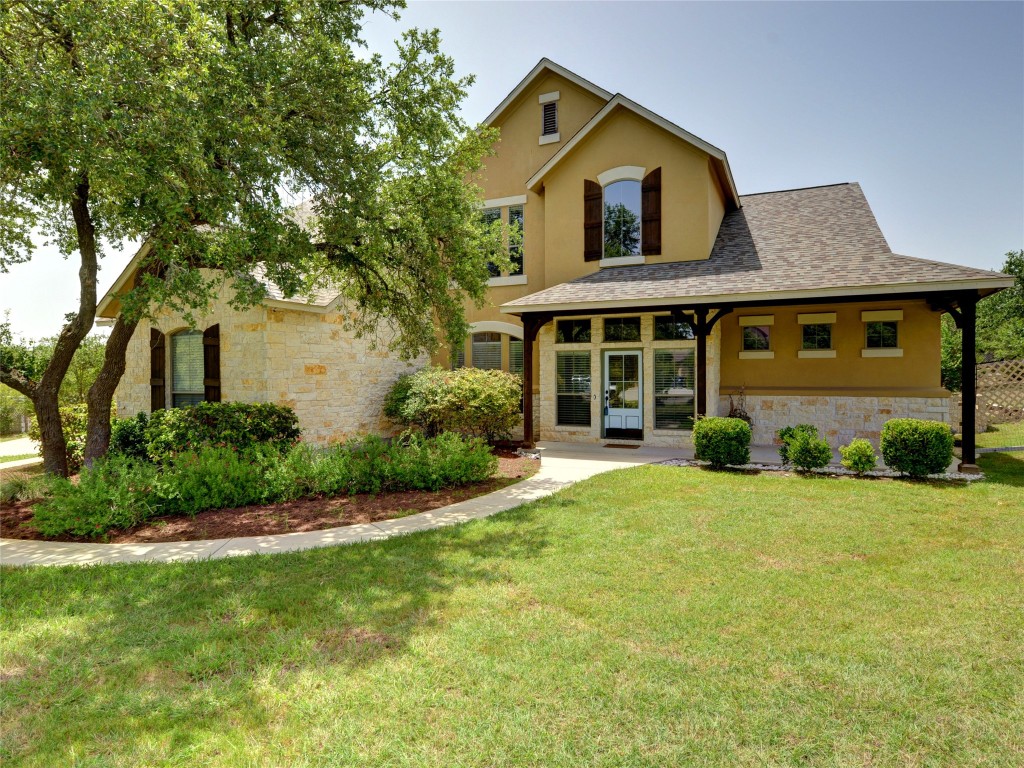 a front view of a house with a yard and garage