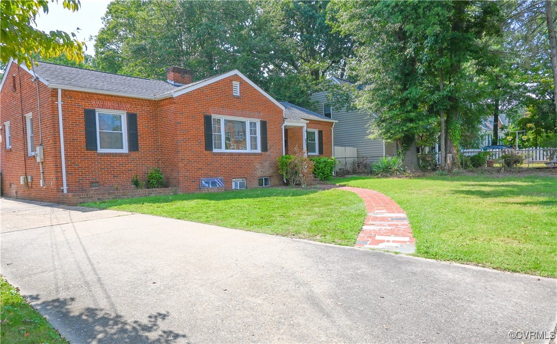 a front view of house with yard and green space