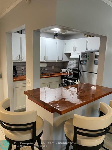 a kitchen with a dining table and chairs