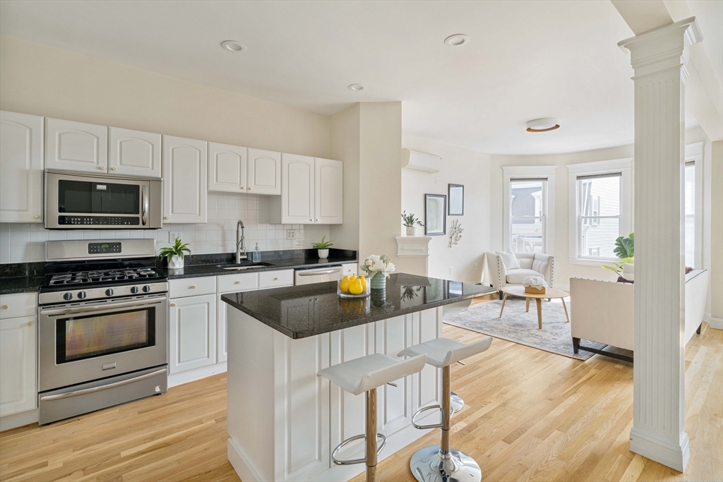 a kitchen with granite countertop a stove and a sink