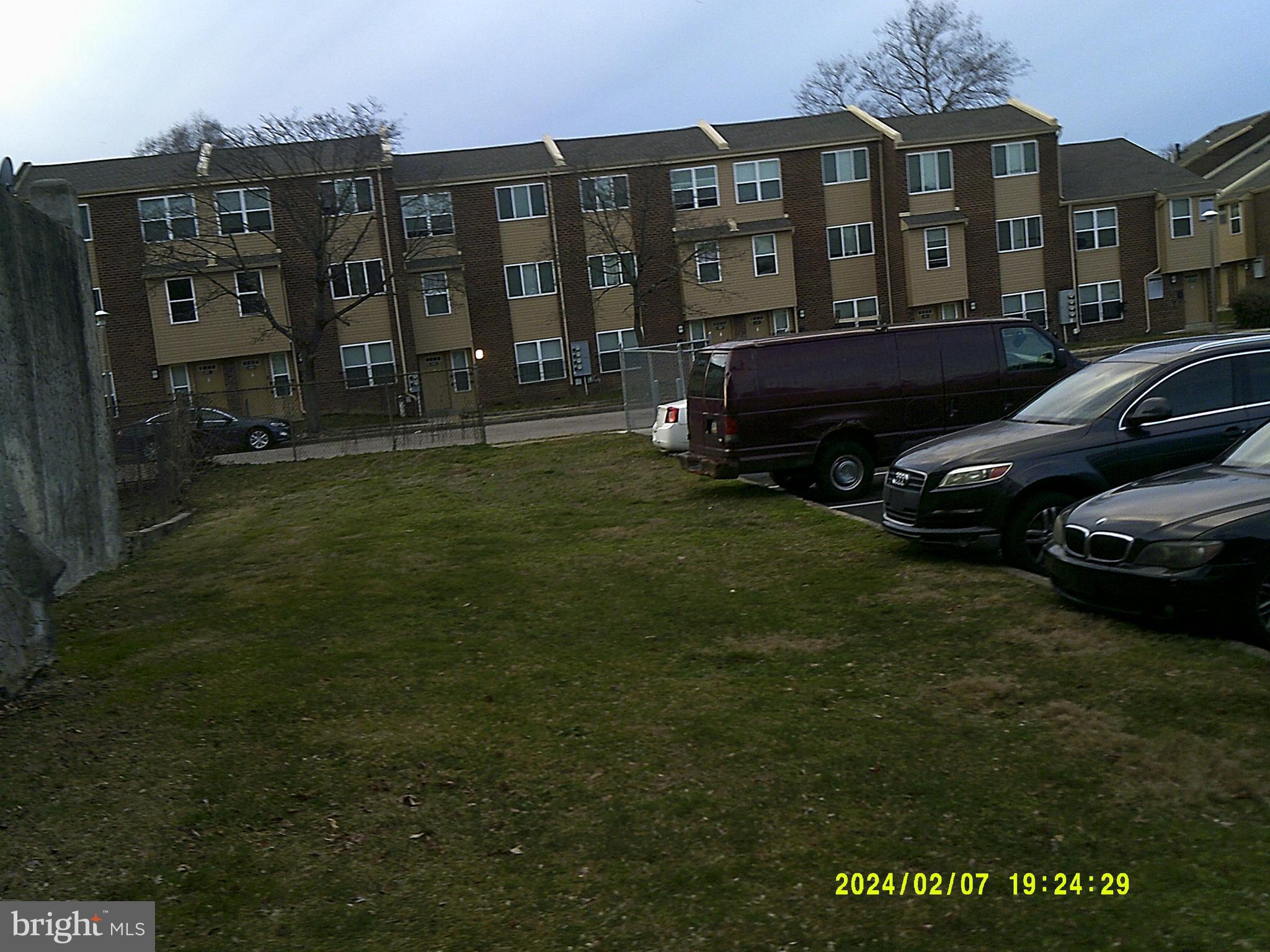 a couple of cars parked in front of a yard