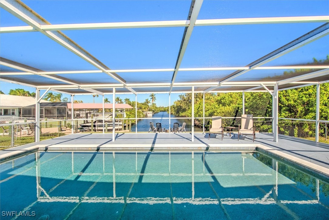 a room with pool table and large windows