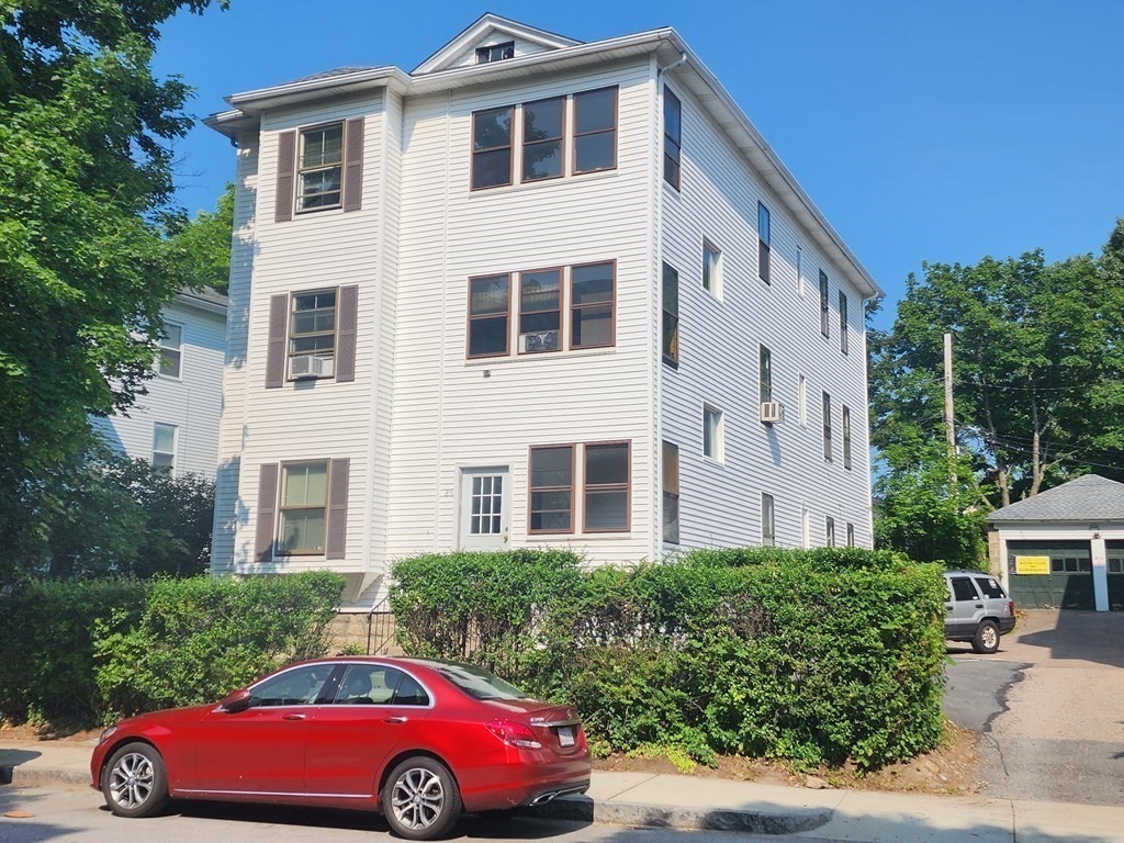 a front view of a house with parking area