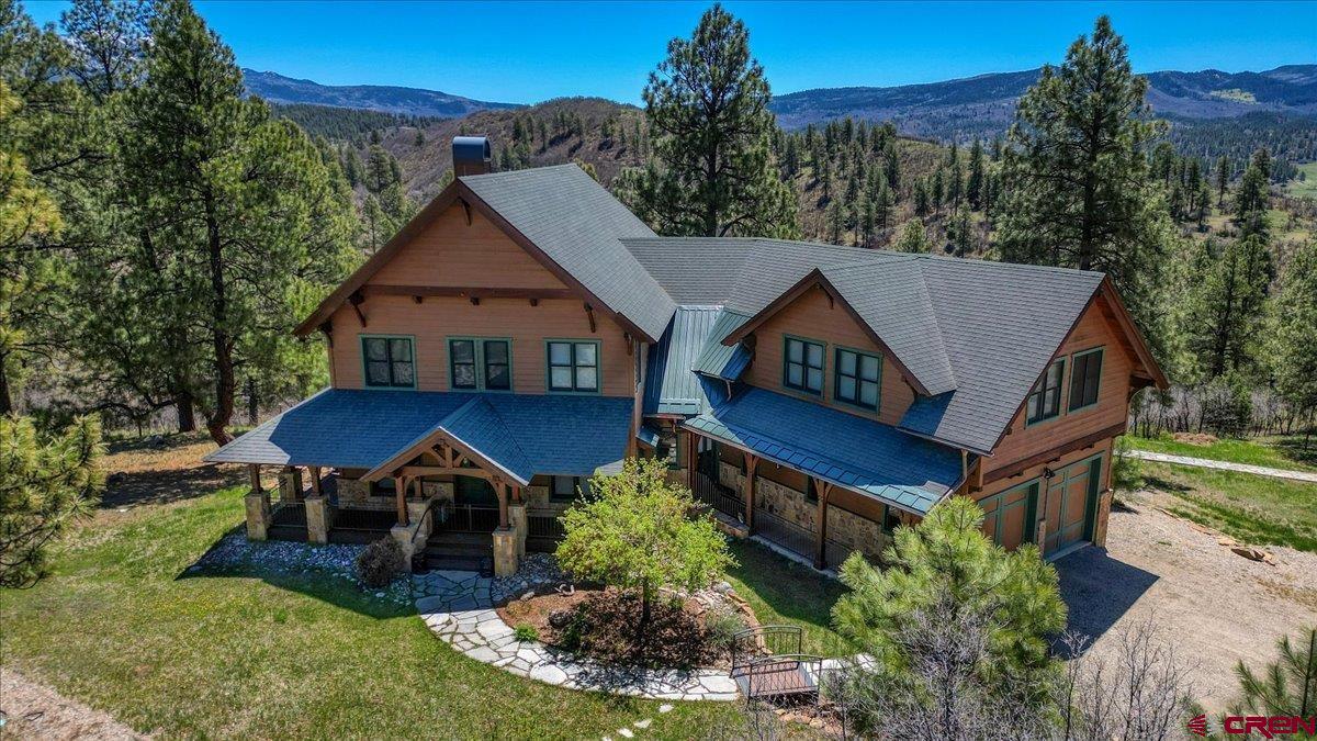 a aerial view of a house next to a yard