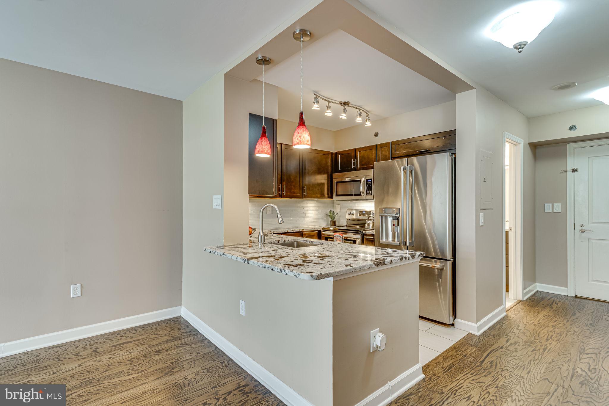 a kitchen that has a cabinets a sink and a refrigerator