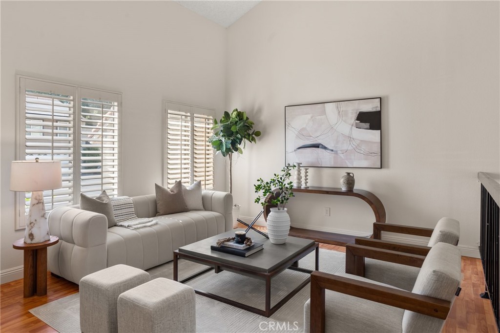 a living room with furniture and a potted plant