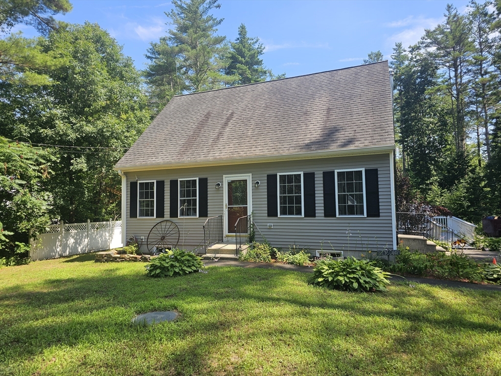 a front view of house with yard and green space