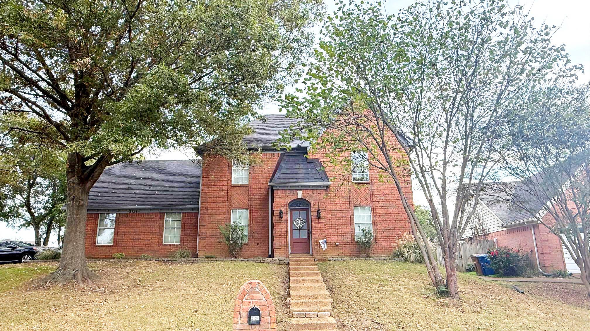 a front view of a house with a yard