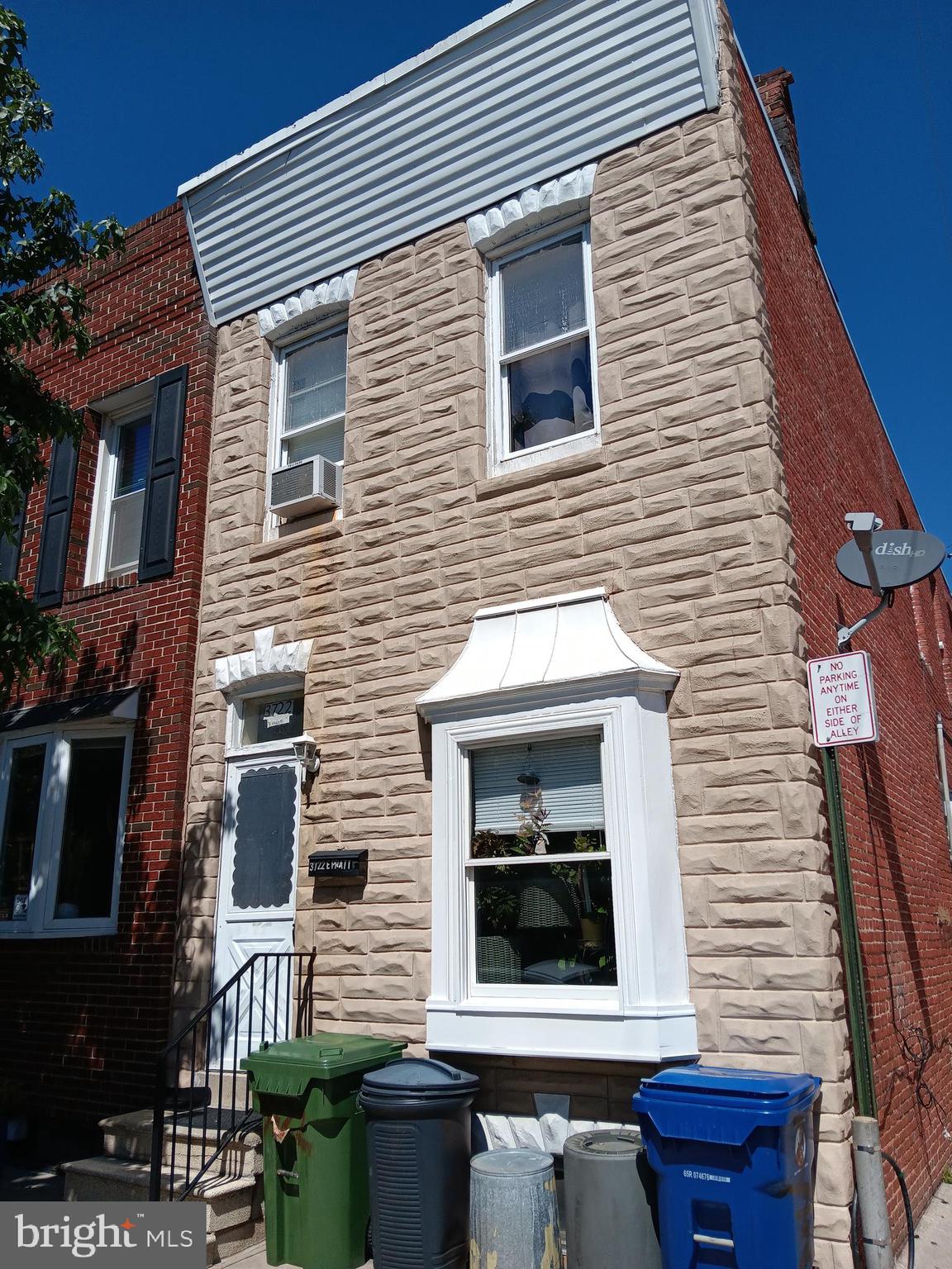 a brick house with a window and balcony