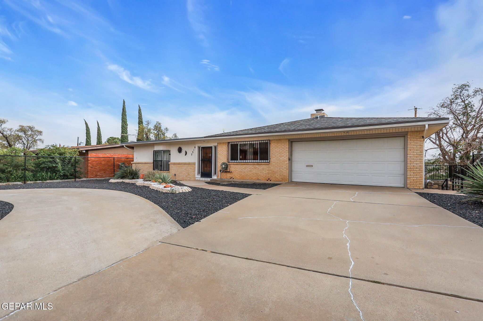 a front view of a house with outdoor space and a garage